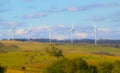 Wind farm turbine on blue sky background. Yellow autumn field. Farm, horse, cows. Royalty Free Stock Photo