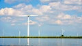 Wind Farm with Two and Three bladed Wind Turbines along the Shore of Veluwemeer Royalty Free Stock Photo