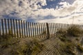 Wind Fence and Afternoon Shadows on the Sand Royalty Free Stock Photo