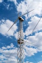 Wind generator on a background of blue sky with clouds Royalty Free Stock Photo