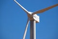 Wind Generator Turbine in Bright Sun Light on the Clear Blue Sky Background. Royalty Free Stock Photo