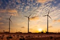 Wind generator turbines sihouettes on sunset