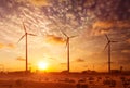 Wind generator turbines sihouettes on sunset