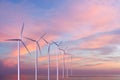 Wind generators turbines in the sea on sunset Royalty Free Stock Photo