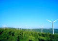 Wind driven generators on the top of mountain with blue sky Royalty Free Stock Photo