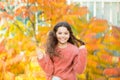 Wind in her hair. Happy little child with colorful leaves in long brunette hair. Autumnal look of small model. Autumn