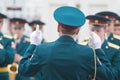 A wind instrument parade - people in green costumes listening to the conductor