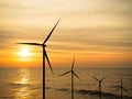 Wind Mill Turbine on Sea Offshore Farm Energy Windmill Sustainable with Red Sunset Ocean Industry on Water, Power Electric Plant Royalty Free Stock Photo