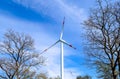 Wind mills in a wind farm producing renewable eletricity on a sunny day