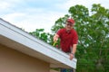 Wind mitigation inspection inspector on a ladder doing inspection on new roof to generate a risk rating Royalty Free Stock Photo