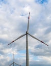 Wind power complex of Rosatom.  Blades on towers of wind turbines at sunset against cloudy sky. Close-up. Adyghe wind farm Royalty Free Stock Photo