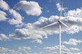 Wind-power plant against white puffy clouds Royalty Free Stock Photo