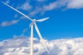 Wind power plant with copy space. Wind farm against a blue sky with white clouds Royalty Free Stock Photo