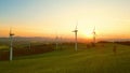 Accelerated rotation of wind power plant at sunset time