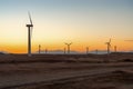 Wind power plants in desert at sunset Royalty Free Stock Photo