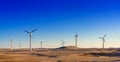 Wind power plants in desert at sunset Royalty Free Stock Photo