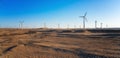 Wind power plants in desert at sunset Royalty Free Stock Photo