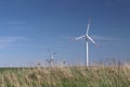 Wind power station in the daytime in the spring. Rotating blades of energy generators. Ecologically clean electricity. Modern tech Royalty Free Stock Photo