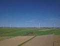 Wind power station in the daytime in the spring. Rotating blades of energy generators. Ecologically clean electricity. Modern tech Royalty Free Stock Photo