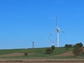 Wind power station in the daytime in the spring. Rotating blades of energy generators. Ecologically clean electricity. Modern tech Royalty Free Stock Photo