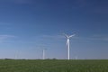 Wind power station in the daytime in the spring. Rotating blades of energy generators. Ecologically clean electricity. Modern tech Royalty Free Stock Photo