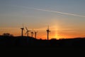 Wind power station in the sunset. Rotating blades of energy generators. Ecologically clean electricity. Modern technologies for t Royalty Free Stock Photo