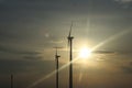 Wind power station in the sunset. Rotating blades of energy generators. Ecologically clean electricity. Modern technologies for t Royalty Free Stock Photo