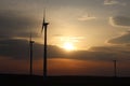 Wind power station in the sunset. Rotating blades of energy generators. Ecologically clean electricity. Modern technologies for t Royalty Free Stock Photo