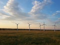 Wind power station in the sunset. Rotating blades of energy generators. Ecologically clean electricity. Modern technologies for t Royalty Free Stock Photo