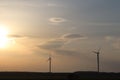 Wind power station in the sunset. Rotating blades of energy generators. Ecologically clean electricity. Modern technologies for t Royalty Free Stock Photo