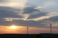 Wind power station in the sunset. Rotating blades of energy generators. Ecologically clean electricity. Modern technologies for t Royalty Free Stock Photo