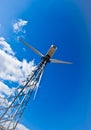 Wind power station - wind turbine against the blue Royalty Free Stock Photo