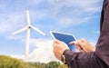 Wind power and sustainable energy field worker with tablet. Engineer or technician in green renewable electricity generation.