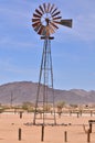 wind Pump in Namibia desert Africa Blue Sky Mountains Wind energy Royalty Free Stock Photo