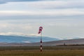 Wind sock on agricultural field at wintertime