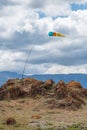Wind sock in the mountains. Wind designator against the blue mountains. Wind sleeve flying on a blue cloudy sky Royalty Free Stock Photo
