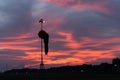 Wind sock under at the dawn under the red orange glowing sky with cirrus and cumulus cloudsBADUNG/BALI-APRIL 14 2019: Wind sock