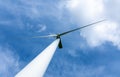 wind turbine against blue sky with white clouds Royalty Free Stock Photo