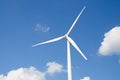 Wind turbine against cloudy blue sky Royalty Free Stock Photo