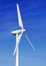 Wind turbine against cloudy blue sky Royalty Free Stock Photo