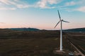 Wind turbine, alternative energy, wind energy, one windmill in a field in the mountains, top view of a wind turbine at sunset Royalty Free Stock Photo