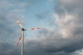 Wind turbine on the background of the blue sky. Clean renewable energy.