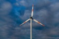 Wind turbine on the background of the blue sky. Clean renewable energy. Royalty Free Stock Photo