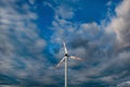 Wind turbine on the background of the blue sky. Clean renewable energy. Royalty Free Stock Photo