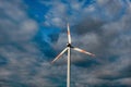 Wind turbine on the background of the blue sky. Clean renewable energy. Royalty Free Stock Photo