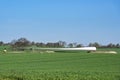 Wind turbine blade on an agriculture field near the planned installation site, preparation for the construction of a renewable Royalty Free Stock Photo