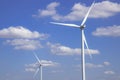 Wind turbine in blue sky with clouds background. Clean energy, renewable energy and ecology concept Royalty Free Stock Photo