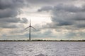 Wind turbine at Dutch coast with threatening dark sky