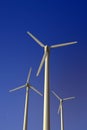 Wind turbine electric generators on a blue sky, vertical Royalty Free Stock Photo