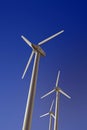 Wind turbine electric generators on a deep blue sky, vertical Royalty Free Stock Photo